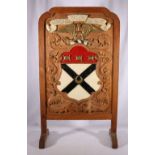 Oak framed firescreen with Clan Johnstone crest bearing the motto Nunquam non Paratus, 86cm tall