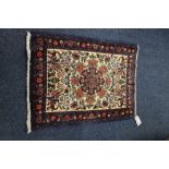 Persian style mat, central meditation over cream ground all over floral design, 104 x 75 cm.