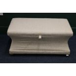 Concave shaped ottoman box raised on bun supports in cream upholstery, 105 cm wide, 49cm tall and 36