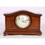 Mahogany and inlaid mantel clock raised on brass ball supports, 26cm wide.
