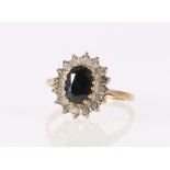 9ct yellow gold diamond and central faceted sapphire set flowerhead ring, 1.8g, size M.