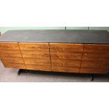 Second half of the 20th century teak and black leathered sideboard raised on chromed metal supports,