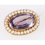 Unhallmarked yellow metal mounted brooch set with central faceted amethyst surounded by pearls, 8.7g