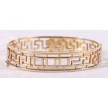 9ct yellow gold greek key pattern hinged bangle, 15.3g.