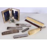 Silver photograph frame, silver easel frame, five silver mounted combs, silver handled brush etc.