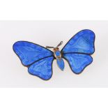 Blue enamelled butterfly brooch with orange stone set eyes.