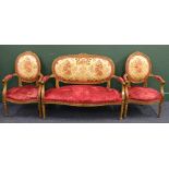 Oak 20th Century carved three piece bergere suite with floral upholstered back, the suite comprising