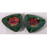 A pair of Moorcroft hibiscus pattern ashtrays, 14cm wide