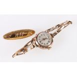 9ct gold 'Lanco' 15 Jewel ladies wristwatch, 14.1g gross and a 9ct gold brooch, 2g.