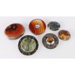 Three white metal mounted carnelian brooches, Scottish silver mounted plaid brooch set with