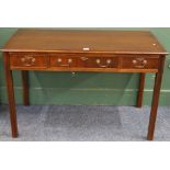 Mahogany desk with three frieze drawers, raised on square reeded supports. 123 cm x 78 x 60cm.