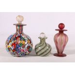 Three Italian glass scent bottles, the largest of millefiori design, 11cm tall, the smallest of