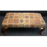 Reproduction mahogany upholstered footstool raised on cabriole supports, 96 cm x 49 cm.