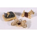 Three Estee Lauder perfume compacts in the form of a scottie dog, cat on pillow and a butterfly (