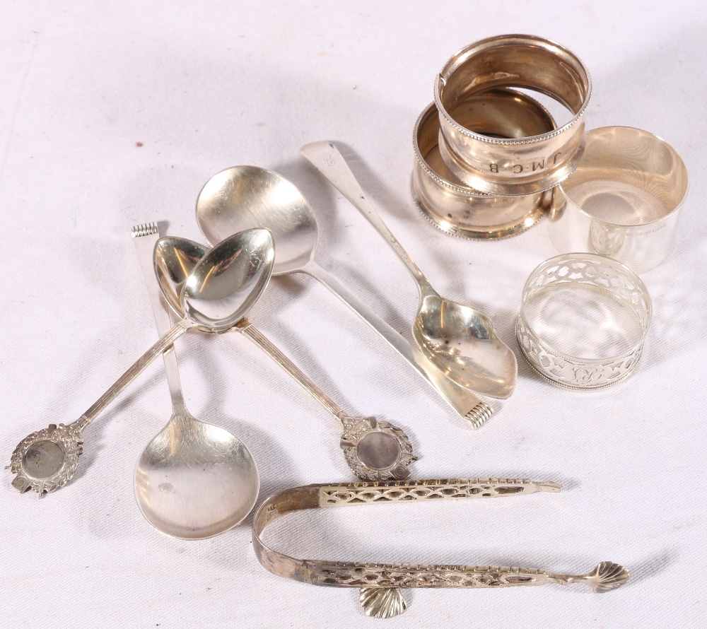 Four silver napkin rings, five spoons and a pair of Victorian sugar tongs, 200g gross