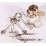 Four silver napkin rings, five spoons and a pair of Victorian sugar tongs, 200g gross