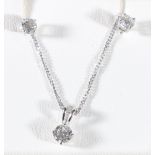 18ct white gold necklace with diamond set pendant and a pair of matching diamond earrings.