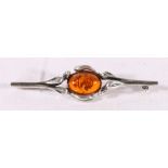Contemporary silver bar brooch set with amber cabochon stone, 6cm long