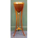 Reproduction yew wood jardiniere stand with splayed tripod base and gilded acorn decoration, 120
