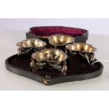 Set of four silver plated table salts with trefoil bowls raised on phoenix supports in case for