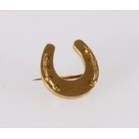 Unhallmarked yellow metal horseshoe brooch, 1.5cm, 1.8g