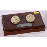 Two early Martins Zodiac golf balls with propeller marks raised on mahogany stand with plaque