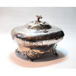 Silver tea caddy of oval, almost cushion shape, embossed with flowers and scrolls, on leafage and
