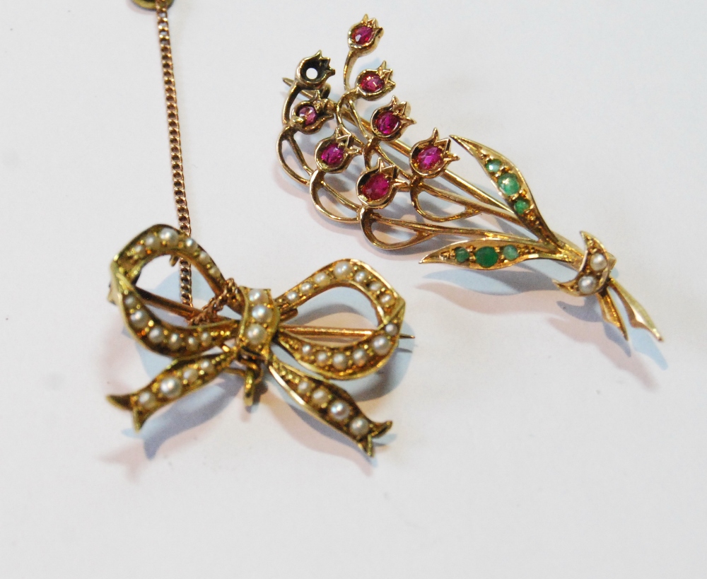 Victorian gold bar brooch with pearls, '15ct', and another with a spray of rubies and emeralds, '