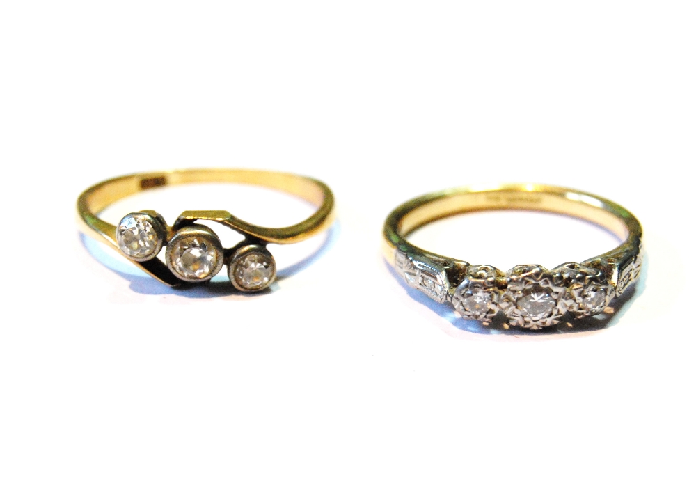 Two diamond three-stone rings, '18ct', 5g.