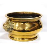 Large oriental brass censer of circular form with opposing dragon masks, 41cm diameter.