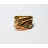 Gold ring modelled as two entwined serpents, the heads with a diamond and an emerald, Birmingham