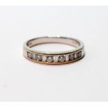 Diamond half eternity ring with six brilliants separated by baguettes, in 18ct white gold, size U.