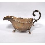 Silver sauce boat with scalloped edge and scrolling handle on paw feet, by Thomas Bradbury & Sons,