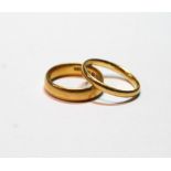 22ct gold band ring, inscribed, size L½, and another, probably 22ct, size N, 8.6g.