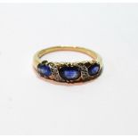 Edwardian style ring of half hoop form with three oval sapphires and scrolls of eight-cut