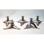 Set of five silver candlesticks modelled as thistles upon triple leaf supports, by Hamilton &