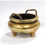 Chinese bronze bowl with rope twist handles, tripod feet and signed to the base, 12cm diameter.