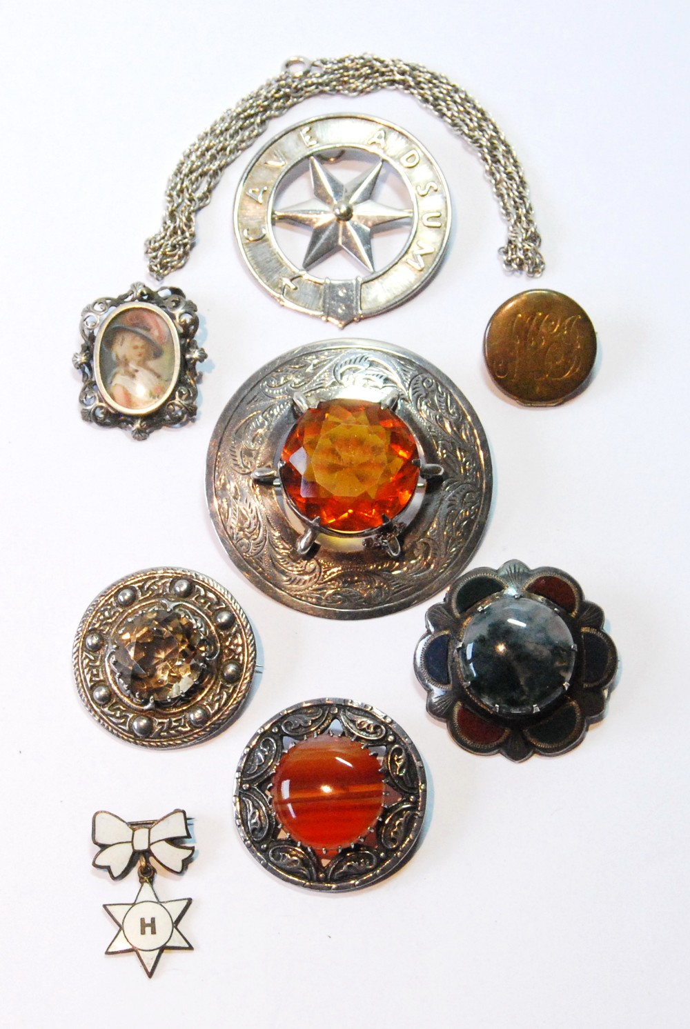 Silver plaid brooch with cairngorm, another with various agates, and seven other items.