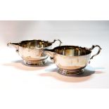 Pair of silver sauce boats of hammered shallow circular shape on moulded bases, by Tessiers, 1933,