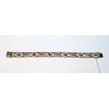 Early 20th century white gold bracelet of six openwork panels and circular panels with tiny
