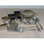 Silver two handled tazza, three napkin rings, three spoons, tongs and six condiments and a cigarette