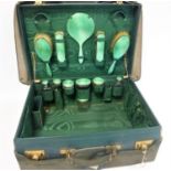 Leather travel dressing case with fitted green silk interior containing silver & green guilloche