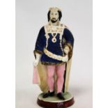 19th century Continental porcelain figure of a medieval king decorated in polychrome enamels and