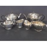 E.p. three piece tea set of polygonal form and another with pierced edges.