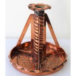 Arts and Crafts copper candlestick, the twist column with three pierced supports and galleried