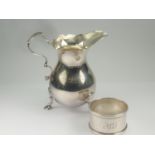 Silver cream jug of plain Georgian pear shape, Birmingham 1937 also a napkin ring. (2).