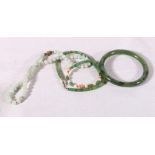 Chinese pale mottled green jade necklace with silver wire work oval clasp, a green hardstone