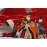 A large Chinese embroidered panel depicting a courtier and attendants, one holding a large fan,