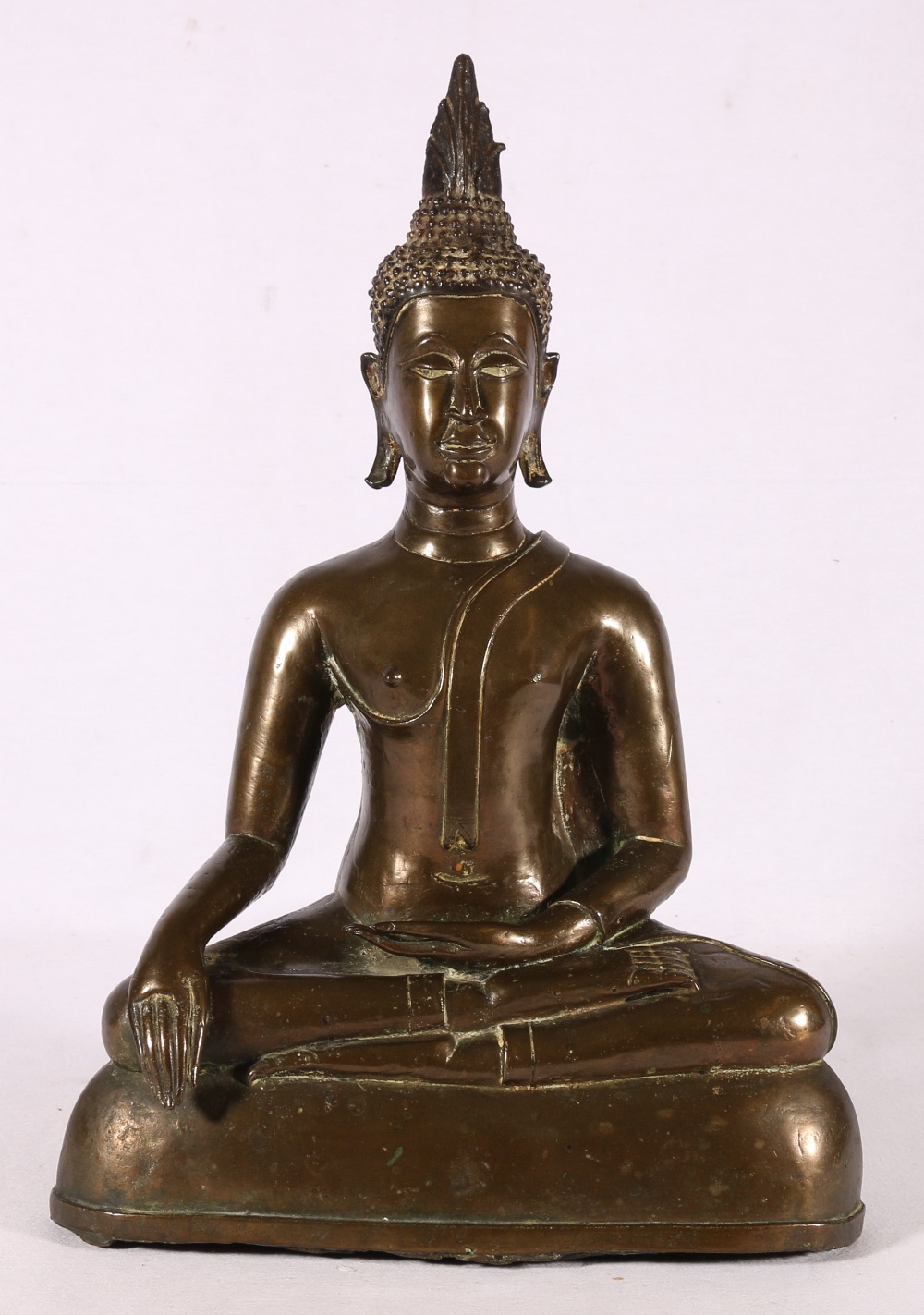 A 19th Century bronze buddha with flaming usnisa on domed base, traces of gilding possibly Thai,