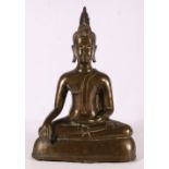 A 19th Century bronze buddha with flaming usnisa on domed base, traces of gilding possibly Thai,